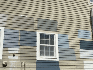 faded sage colored exterior clapboards with a bunch of new paint color samples painted